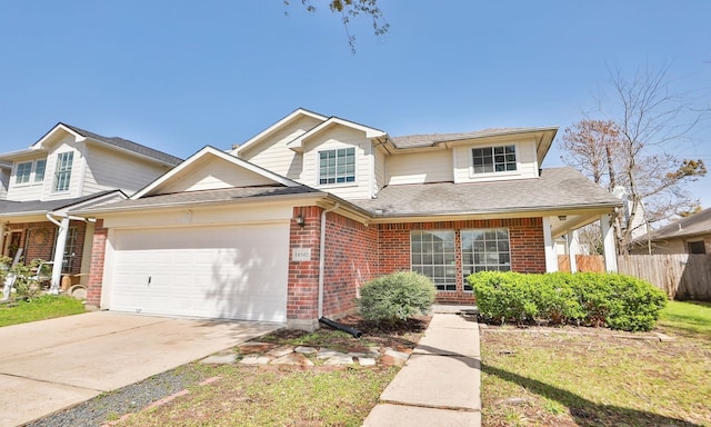 traditional-style home featuring a garage, brick siding, fence, concrete driveway, and roof with shingles