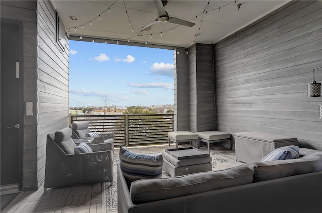 exterior space with a view of city, floor to ceiling windows, rail lighting, a ceiling fan, and wooden walls