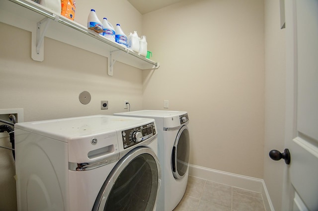 laundry room with light tile patterned floors and independent washer and dryer