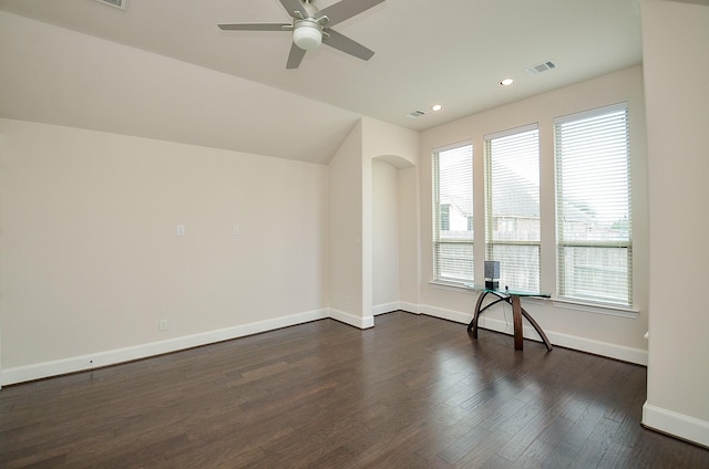 spare room with dark hardwood / wood-style flooring, lofted ceiling, and ceiling fan