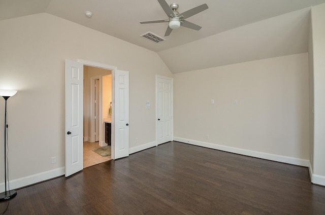 unfurnished bedroom featuring dark wood-type flooring, ceiling fan, and vaulted ceiling