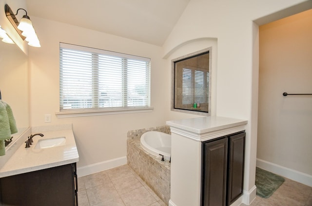 bathroom with vanity, tiled tub, tile patterned flooring, and lofted ceiling