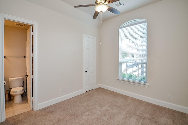 empty room featuring light carpet and ceiling fan