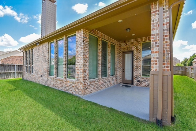 exterior space with a patio area and a lawn