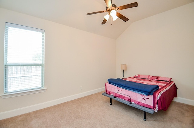 bedroom with lofted ceiling, light colored carpet, and ceiling fan