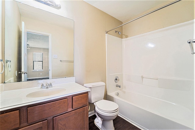 full bathroom with  shower combination, wood finished floors, vanity, and toilet