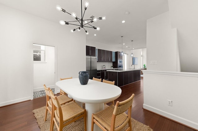 dining area featuring dark hardwood / wood-style floors and a chandelier