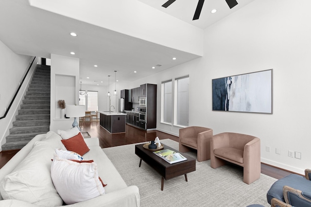 living room with ceiling fan and light hardwood / wood-style flooring