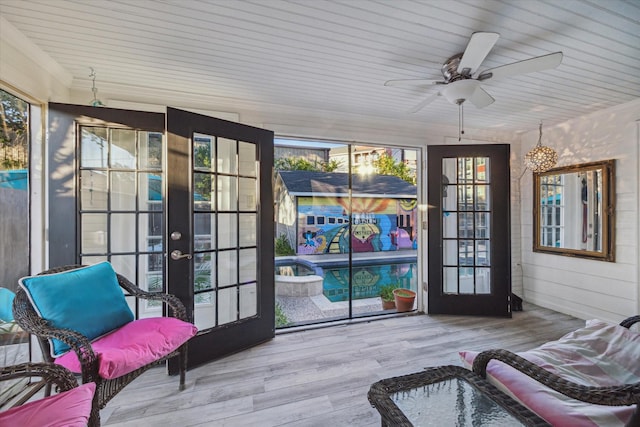 sunroom / solarium featuring ceiling fan and french doors