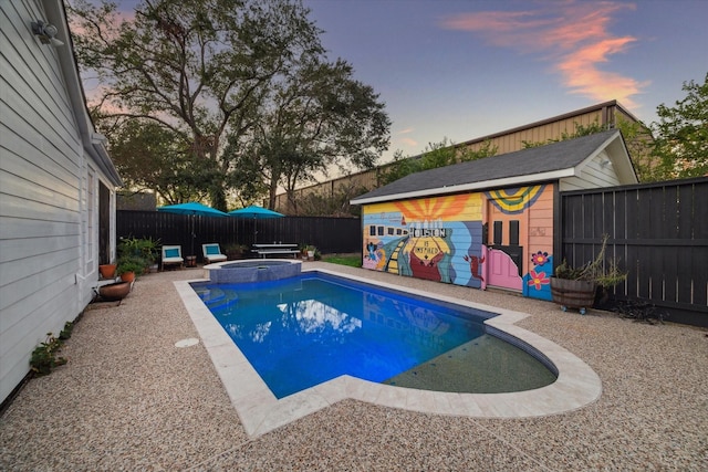 pool at dusk with an in ground hot tub