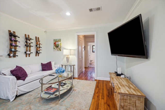 living room with crown molding and dark wood-type flooring