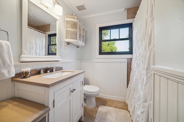 bathroom featuring ornamental molding, plenty of natural light, toilet, and vanity