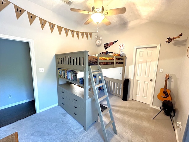 bedroom with light carpet, vaulted ceiling, and ceiling fan