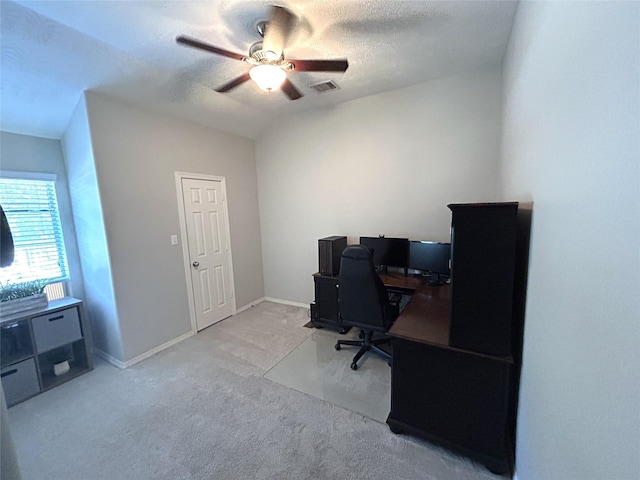 office area with ceiling fan, light colored carpet, vaulted ceiling, and a textured ceiling