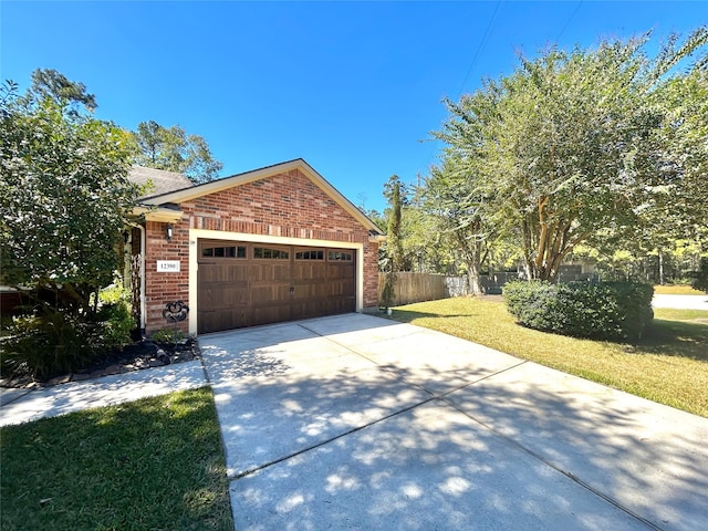 view of side of property featuring a garage and a yard