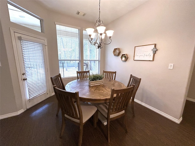 dining area featuring an inviting chandelier and lofted ceiling