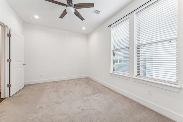 empty room featuring light colored carpet and ceiling fan