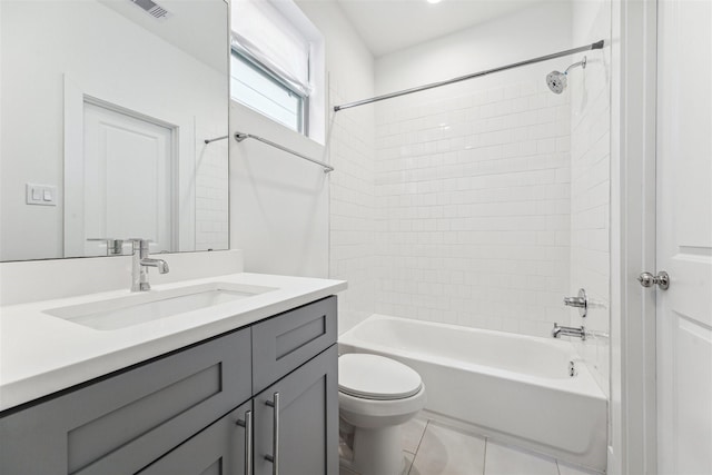 full bathroom with tile patterned flooring, vanity, toilet, and tiled shower / bath