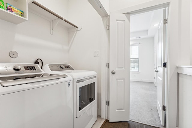 washroom with separate washer and dryer and dark colored carpet