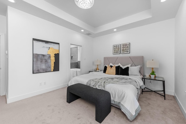 bedroom featuring a raised ceiling, light colored carpet, and a chandelier