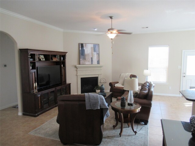 living room featuring light tile patterned flooring, ceiling fan, and crown molding