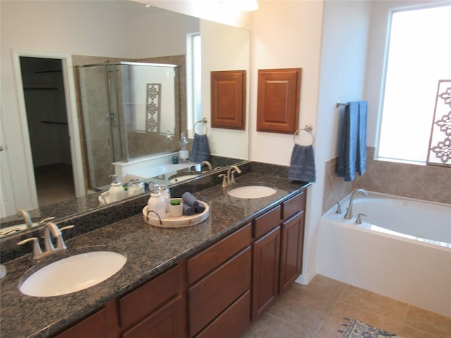 bathroom with vanity, tile patterned flooring, and plus walk in shower