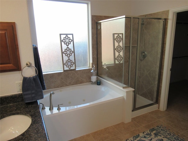 bathroom featuring tile patterned flooring, independent shower and bath, and sink