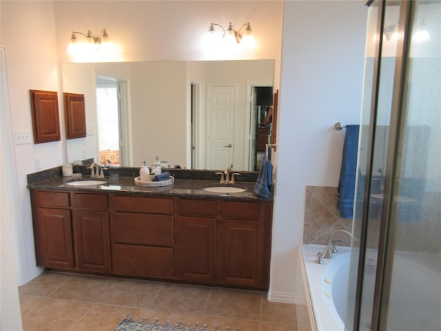 bathroom featuring independent shower and bath, vanity, and tile patterned flooring