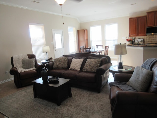 tiled living room featuring lofted ceiling, crown molding, and a wealth of natural light