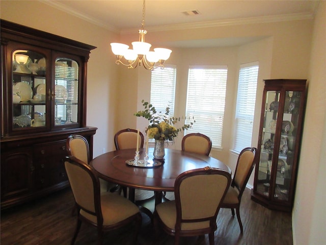 dining area with ornamental molding, dark hardwood / wood-style flooring, and a chandelier