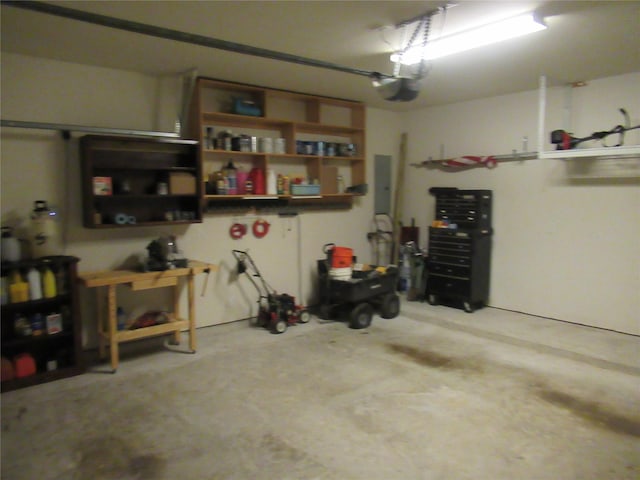 garage with a garage door opener and electric panel