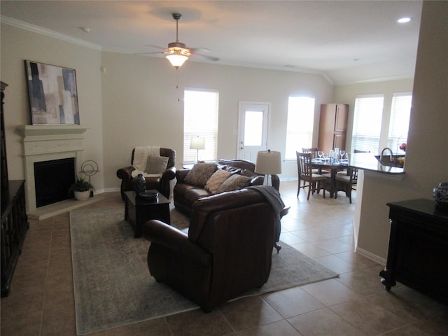 tiled living room with crown molding and ceiling fan