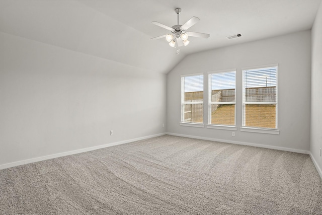 carpeted spare room with lofted ceiling and ceiling fan