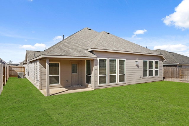 back of house featuring a lawn and a patio area