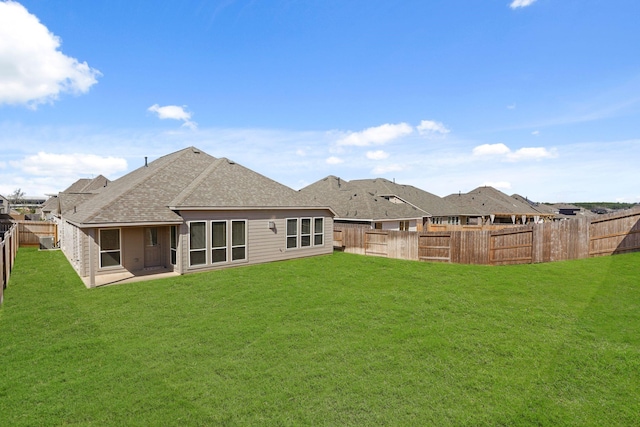 back of property with a yard and a patio