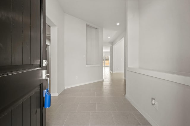 corridor with light tile patterned floors