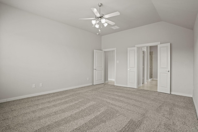 unfurnished bedroom featuring ceiling fan, lofted ceiling, and light carpet