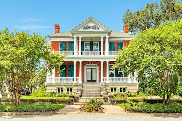 1428 Ball, Galveston, TX 77550 - neoclassical / greek revival house featuring a balcony, french doors, a porch, stairway, and a chimney