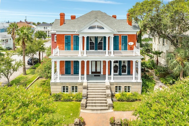 1428 Ball, Galveston, TX 77550 - neoclassical / greek revival house featuring a balcony, covered porch, stairs, and a chimney
