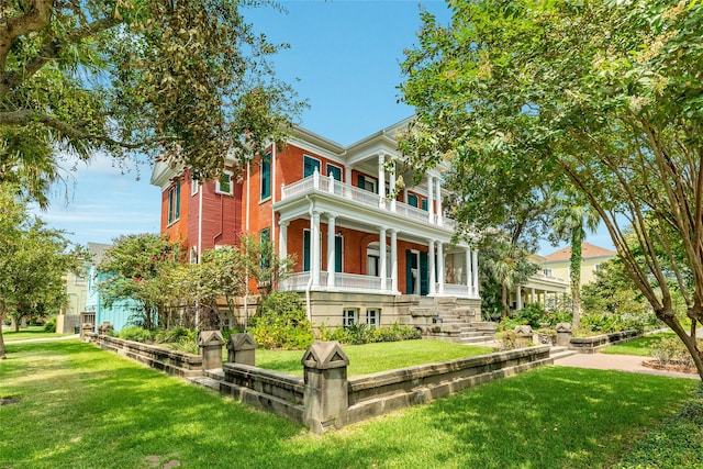 1428 Ball, Galveston, TX 77550 - view of front of home with a balcony, covered porch, and a front yard
