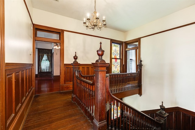 1428 Ball, Galveston, TX 77550 - hall with an upstairs landing, wainscoting, dark wood-type flooring, and a chandelier