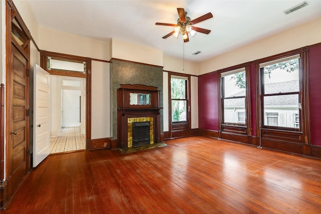 1428 Ball, Galveston, TX 77550 - unfurnished living room featuring hardwood / wood-style floors, a fireplace with flush hearth, ceiling fan, and baseboards