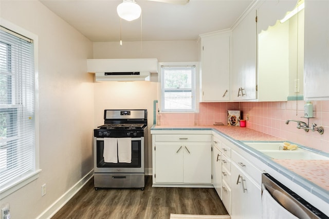 1428 Ball, Galveston, TX 77550 - kitchen with stainless steel range with gas cooktop, dishwasher, a sink, dark wood finished floors, and tasteful backsplash