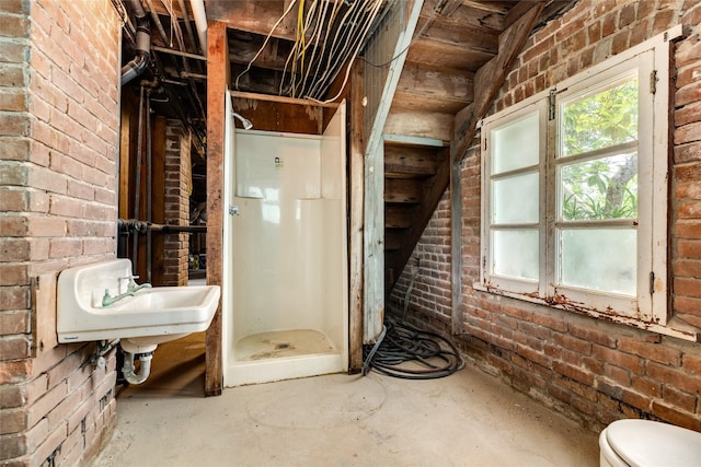 1428 Ball, Galveston, TX 77550 - bathroom with a stall shower, a sink, toilet, and brick wall