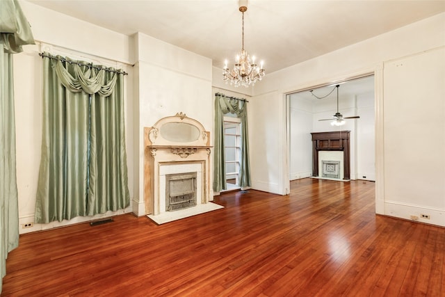 1428 Ball, Galveston, TX 77550 - unfurnished living room featuring a fireplace, a chandelier, wood finished floors, and a ceiling fan