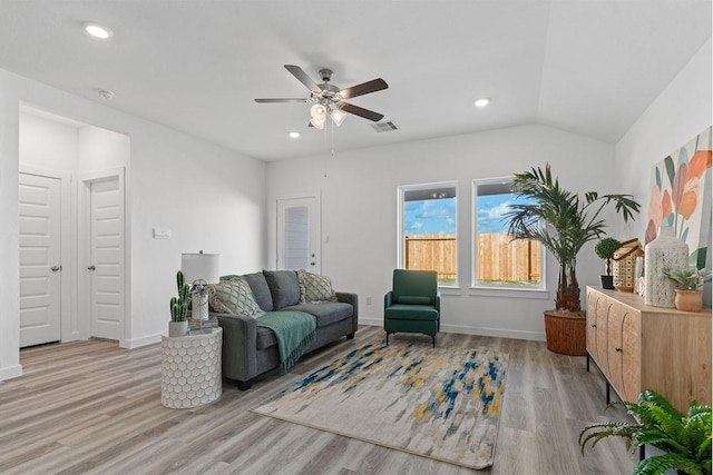 living room featuring vaulted ceiling, ceiling fan, and light wood-type flooring