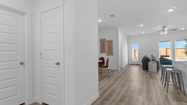 corridor with light wood-type flooring