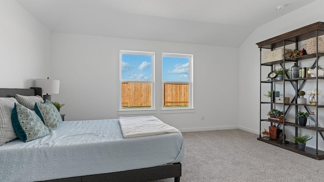 bedroom with vaulted ceiling and carpet