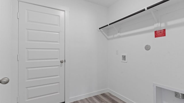 laundry area with hookup for a washing machine, electric dryer hookup, and light wood-type flooring