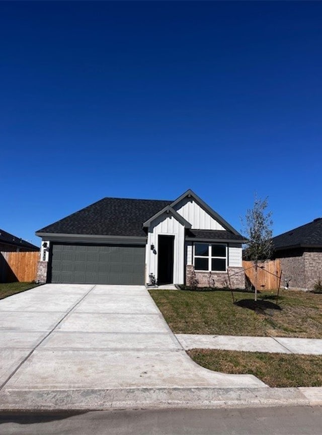 view of front of property with a garage and a front lawn